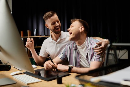 Gay couple in casual attire working together at computer desk.