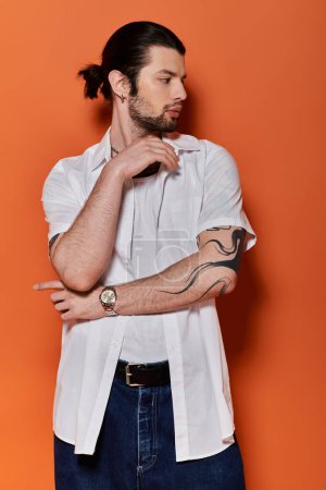 A stylish Caucasian man proudly displays a captivating tattoo on his arm.