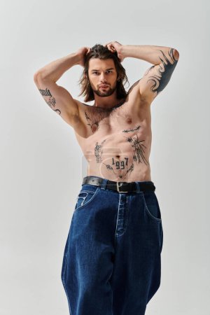 Handsome Caucasian man proudly displays chest tattoos.