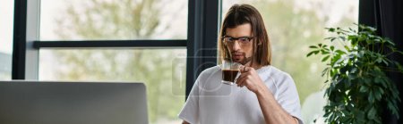 Caucasian business professional enjoying coffee while working on computer.