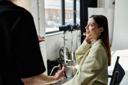Woman receiving makeup application from talented artist in a chair.
