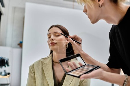Professional makeup artist applying makeup to enhance a womans natural beauty.