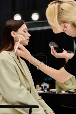 A woman enjoying makeup session with stylist.