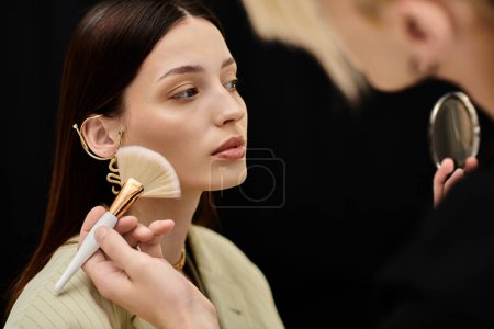 Attractive woman enjoying makeup session with stylist.