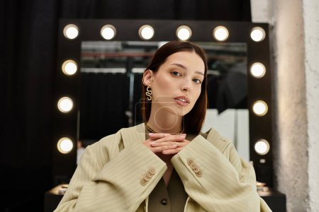 Téléchargez les photos : Woman admiring makeup next to mirror. - en image libre de droit