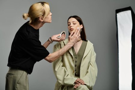 A makeup artist beautifies a client.