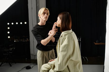 A makeup artist is skillfully applying makeup to a womans face.