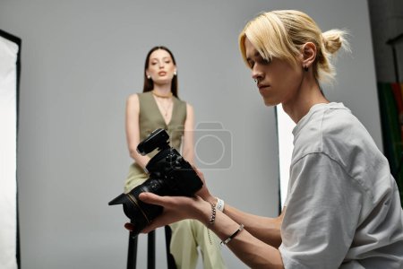 Appealing man taking photos of young woman on camera.