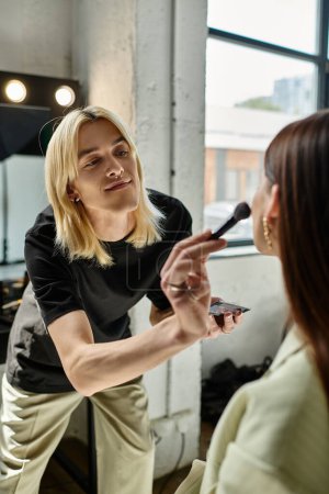 Handsome makeup artist transforms a womans look.