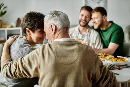 A gay couple embraces during a dinner with their family, showcasing love, acceptance, and heartwarming connection.