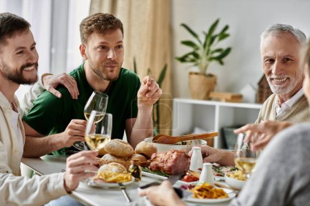 A gay couple shares a meal with their family at home.