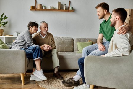 A gay couple sits on a couch with parents, sharing a moment of togetherness.