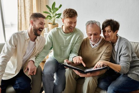 A gay couple and parents look through a photo album together.