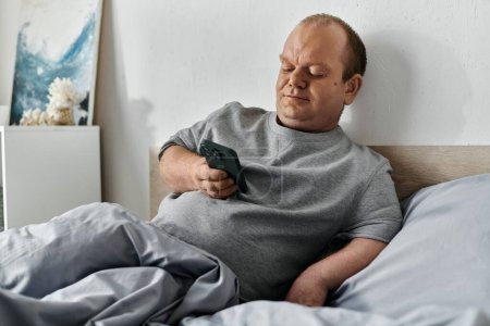 A man with inclusivity sits in bed, using his smartphone, starting his day.