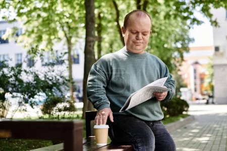 A man with inclusivity sits on a park bench, reading a newspaper and enjoying a cup of coffee.