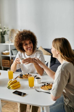Two women enjoy a leisurely breakfast together at home.