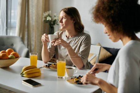 Two women enjoy a leisurely breakfast together at home.