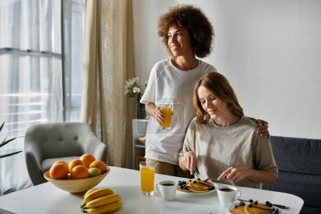 Two women share a meal together at home.