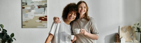 A loving lesbian couple enjoys a quiet moment at home with coffee in hand.