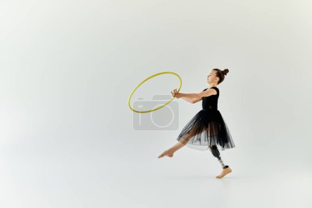 A young girl with a prosthetic leg performs a graceful hula hoop routine.