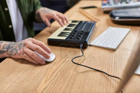 Photo for A close-up of an Asian mans hands working on music production in his studio. - Royalty Free Image