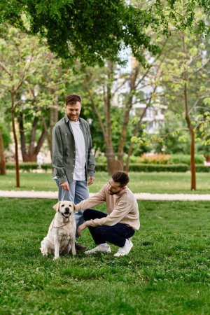 A bearded gay couple spends time with their Labrador retriever in a green park.