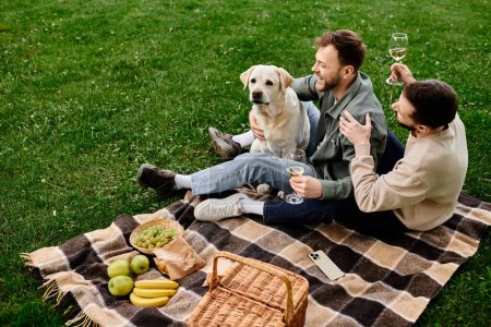 A gay couple enjoys a picnic with their labrador dog in a green park.