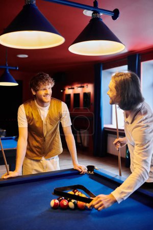 Friends play billiards together, dressed casually in stylish attire.