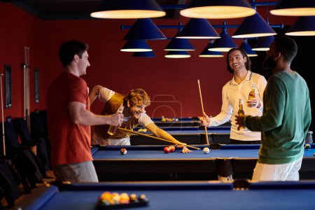 Friends play billiards in a dimly lit room, enjoying a friendly competition.
