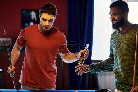 Friends play billiards and share a beer in a casual setting.