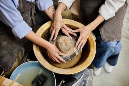 A couple works together to create pottery in a cozy studio.