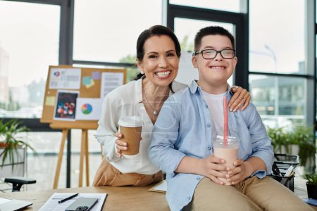 A mother and her son with Down syndrome are smiling while working in an office.