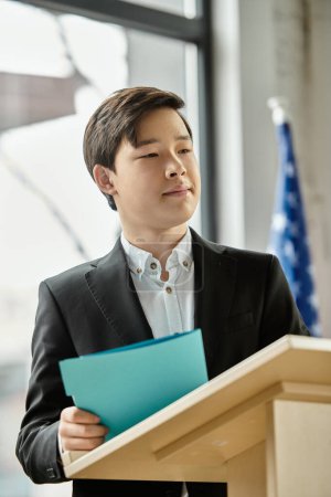 Teenage boy in a suit stands at a podium, ready to address a UN Model.