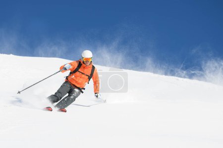 Mountaineering skier during powder descent