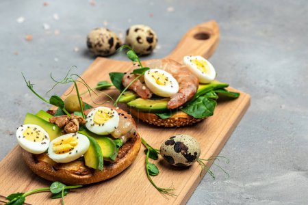 Photo for Open sanwich with wholemeal bread, egg, spinach, avocado, shrimps, Ketogenic breakfast. superfood concept. Healthy clean eating. top view. place for text. - Royalty Free Image