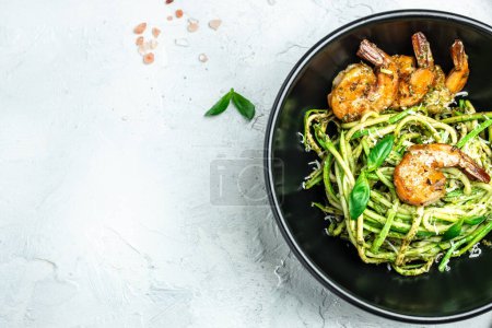 Photo for Pasta spaghetti zucchini basil pesto sauce and grilled shrimp, Vegetarian vegetable pasta, Restaurant menu, dieting, cookbook recipe top view. - Royalty Free Image