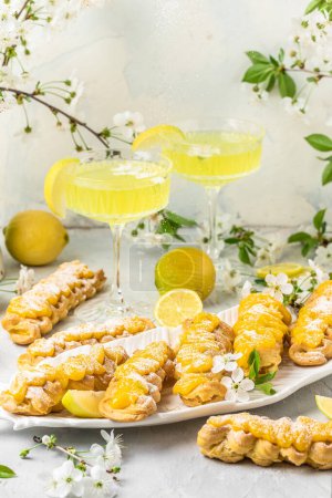 Photo for Limoncello. Traditional italian homemade alcoholic drink in glass with pieces of lemon, sweet Italian lemon liqueur. vertical image. top view. place for text. - Royalty Free Image