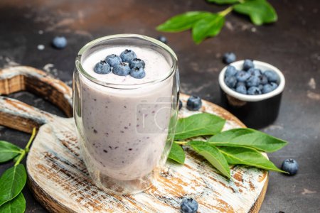 Photo for Blueberry jogurt, Tasty blueberry smoothie in glass on a dark background, place for text. - Royalty Free Image
