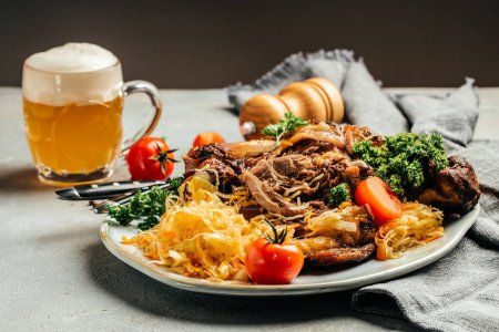 Photo for Roasted pork knuckle with beer and sauerkraut. Oktoberfest menu. Traditional dish in German cuisine schweinshaxe. - Royalty Free Image