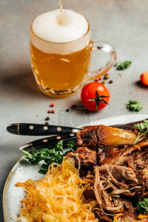 Photo for Eisbein with sauerkraut salad and beer. Oktoberfest menu, German cuisine - Royalty Free Image