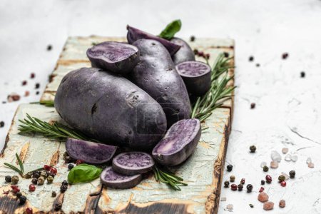 Photo for Organic purple sweet potato. Raw sweet potatoes or batatas. pomoea batatas. Batata potato. vegan food ingredient. banner, menu, recipe place for text, top view. - Royalty Free Image