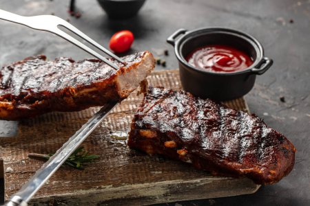 Grilled and smoked ribs with barbeque sauce. Delicious barbecued ribs. Food recipe background. Close up.