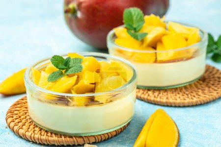 Photo for Mango Panna cotta, Mango desserts with pieces of fresh mango on a light background. top view, - Royalty Free Image