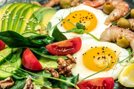 Photo for Shrimps, prawns, soft fried egg, fresh salad, tomatoes, cucumbers and avocado on a light background. Ketogenic diet breakfast. Keto, paleo lunch. Top view. - Royalty Free Image