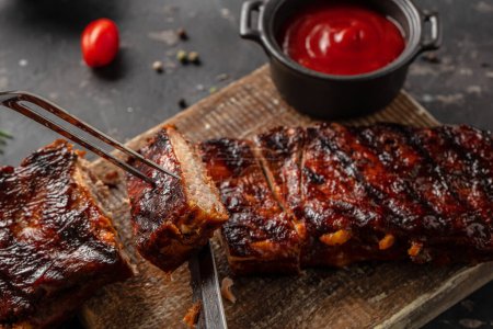 Photo for Grilled and barbecue ribs pork on a wooden board, banner, menu, recipe place for text, top view. - Royalty Free Image