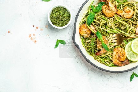 zucchini pasta shrimp with basil pesto sauce. Healthy fats, clean eating for weight loss. place for text, top view.