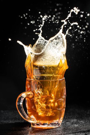 Photo for Glass of splashing beer. Freeze motion splash drops of beer foam. - Royalty Free Image