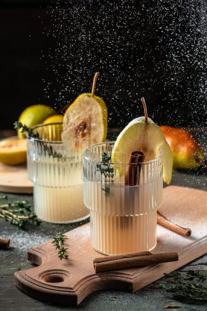 Foto de Spicy cocktail with pears and thyme. Mulled wine. vertical image. top view. place for text - Imagen libre de derechos