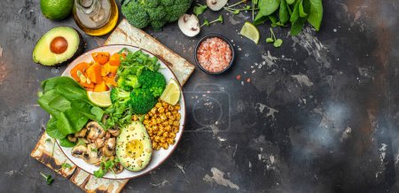 Photo for Buddha bowl, Avocado, mushrooms, broccoli, spinach, chickpeas pumpkin. healthy and balanced food. Long banner format top view - Royalty Free Image