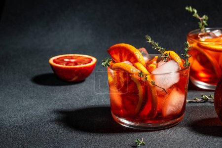 Photo for Aperitif alcohol cocktail ice and Sicilian red oranges. Summer refreshing cocktail, place for text, top view, - Royalty Free Image